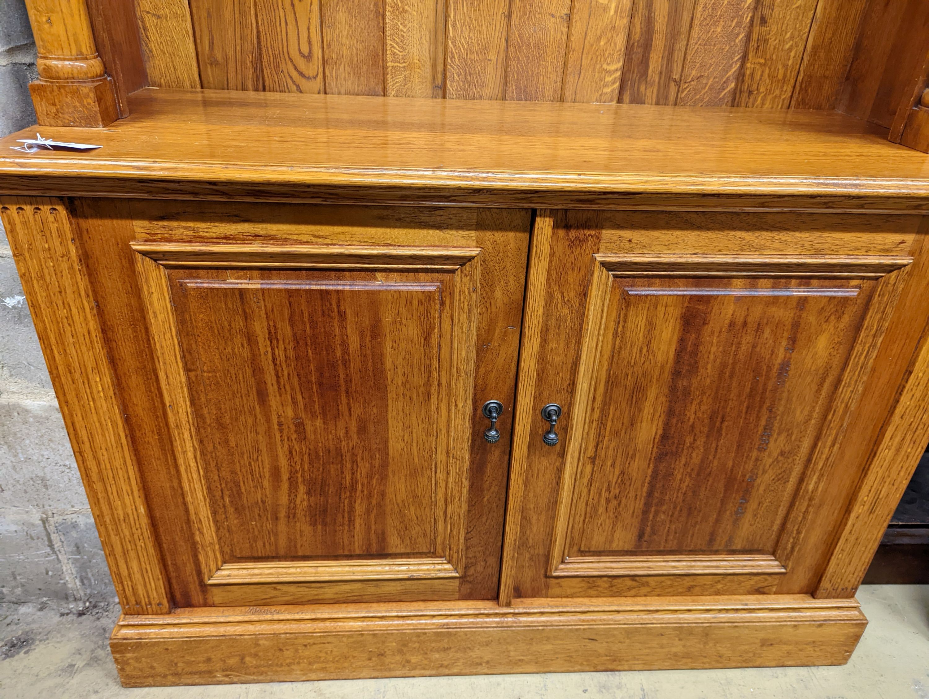 A Victorian style pale oak open bookcase, length 122cm, depth 46cm, height 229cm